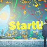Man standing in front of rocket with 'startup' on wall. Tips to Launch A Successful Startup Business.